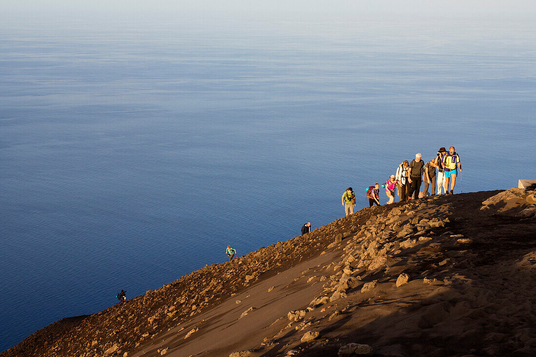 Tourists on the summit of Stromboli Volcano at sunset, Stromboli Island, Aeolian Islands, Lipari Islands, Tyrrhenian Sea, Mediterranean Sea, Italy, Europe