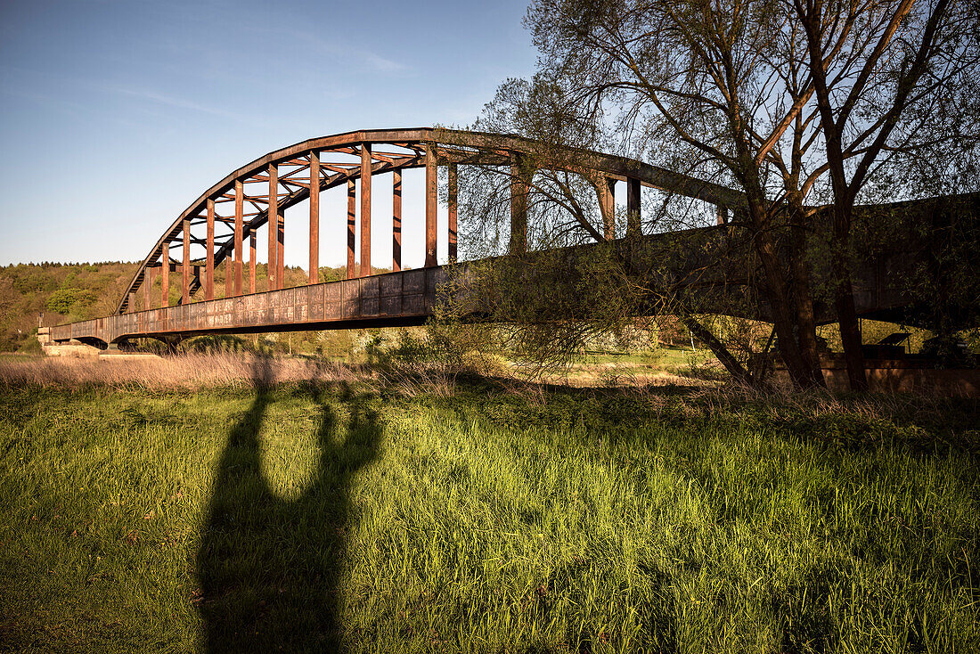 old and rusty railway bridge across the river Weser near Corvey, Hoexter, North Rhine-Westphalia, Germany