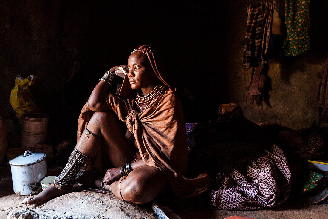 Himba woman in her hut, Kunene, Namibia