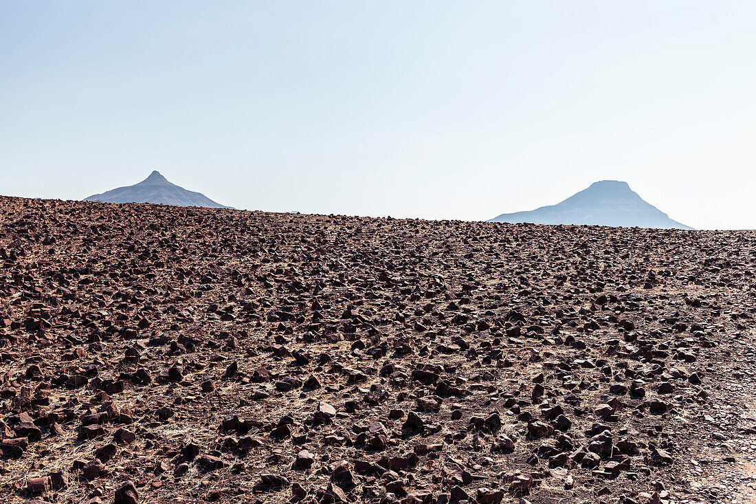 Two mountain tops in the vast rocky desert of Damaraland, Kunene, Namibia.