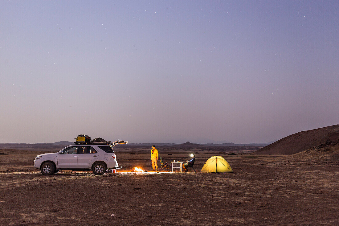 Two men camping in the plains of the Damaraland, Kunene, Namibia