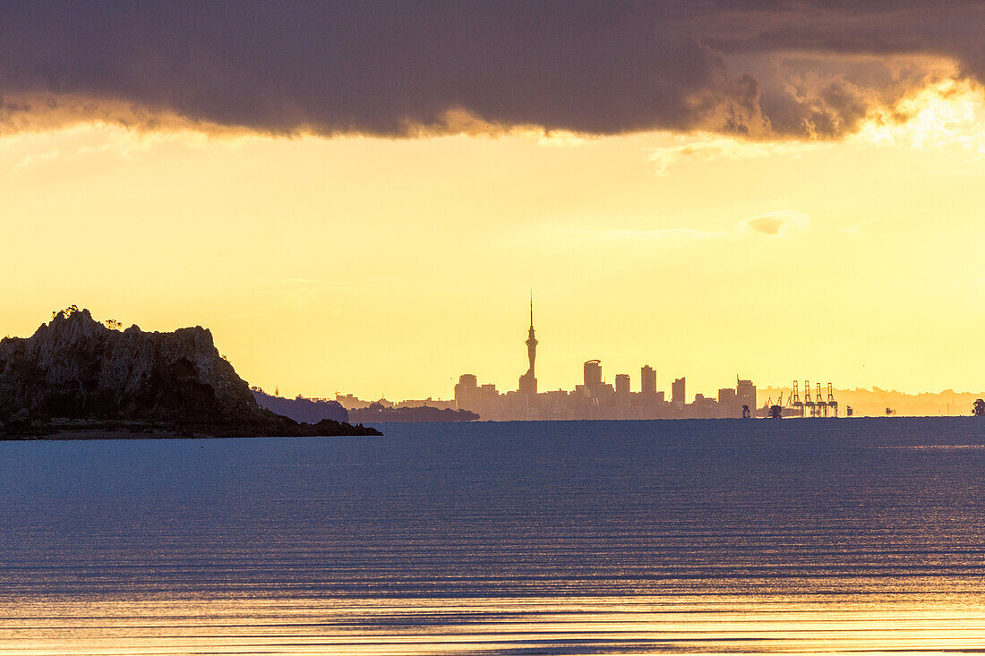 Auckland's skyline seen from Waiheke Island, dramatic sky, Hauraki Gulf, North Island, New Zealand