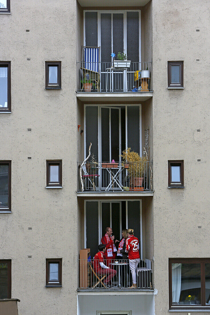 Fans of soccer club 1. FC Bayern Munich celebrating on a balcony, Maxvorstadt, Munich, Upper Bavaria, Bavaria, Germany