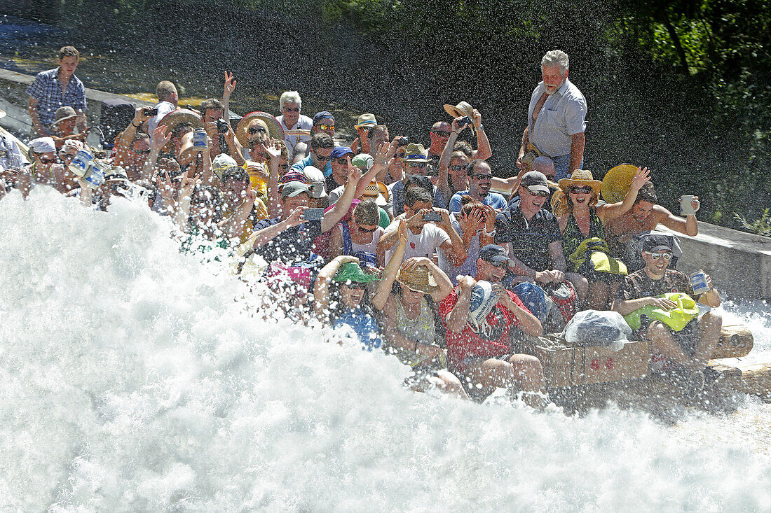 People on a traditional wooden raft on a shute in Thalkirchen, Munich, Upper Bavaria, Bavaria, Germany