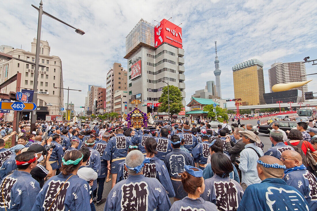 Japanese wearing indigo blue yukata carrying portable shrine during Sanja Festival, Asakusa, Taito-ku, Tokyo, Japan