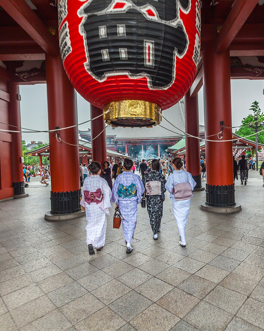 Four Japanese women wearing kimono and walking in front of Senso-ji Temple in Asakusa, Taito-ku, Tokyo, Japan