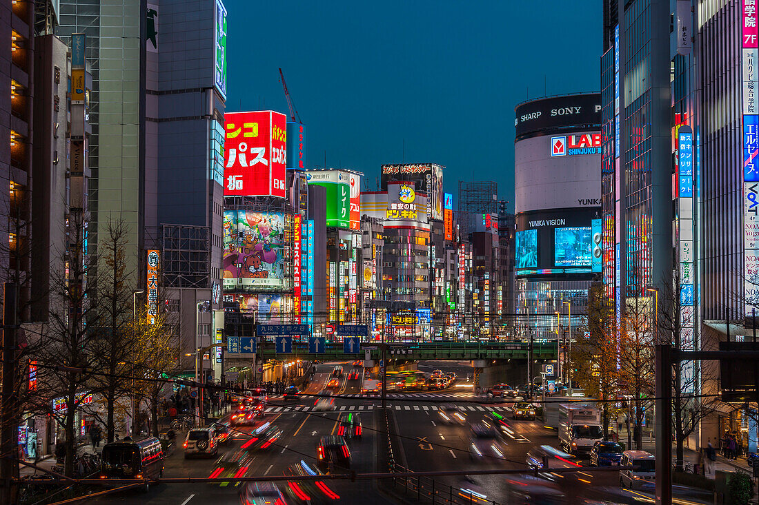 Yasukuni Kaido Street with billboards and moving cars at blue hour, Shinjuku, Tokyo, Japan