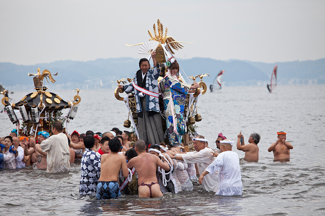 Omikoshi portable shrine carried into sea during Seijin-Sai-Festival at Enoshima beach, Fujisawa, Kanagawa Prefecture, Japan