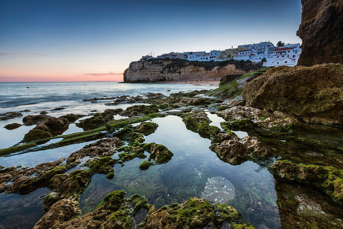 Sunset on the village perched on the promontory overlooking the beach of Carvoeiro Algarve Lagoa Faro District Portugal Europe.