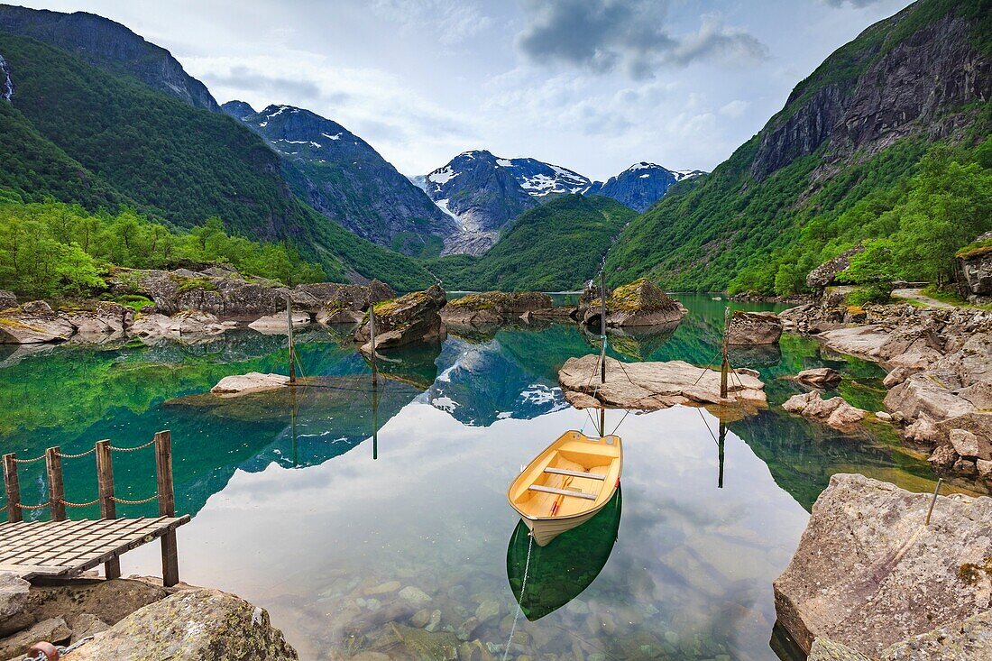 Boat at lake Bondhus and glacier Bondhusbreen in the background as a part of the Folgefonna Glacier, Folgefonna National Park, Kvinnherad,Hordaland, Norway.