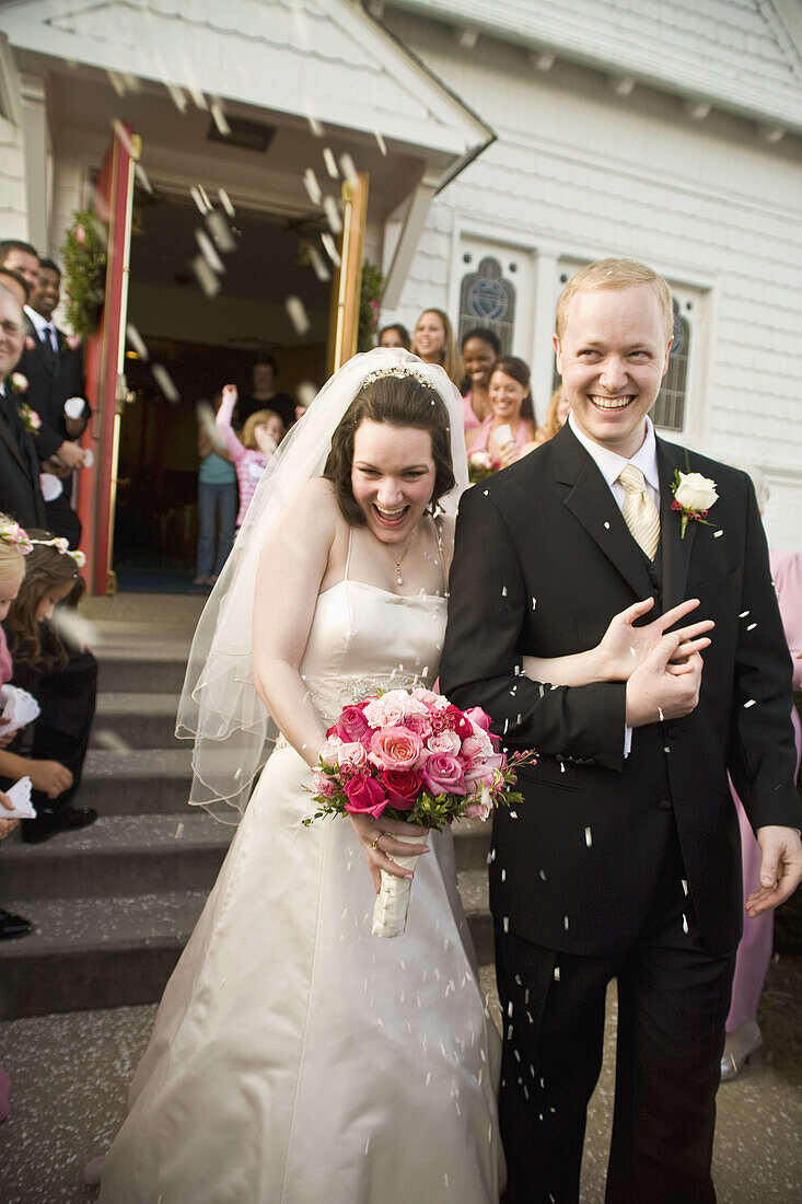 Wedding guests throwing rice at newlyweds, Fredrick, Maryland