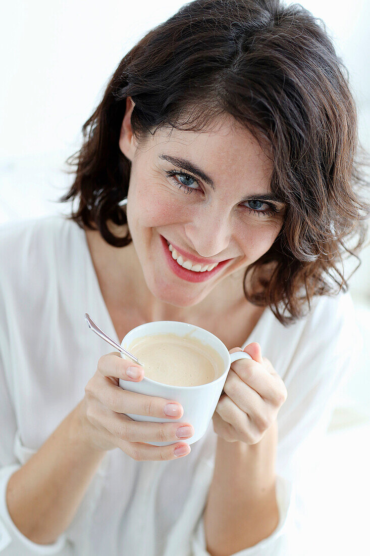Portrait of Woman holding cup of coffee