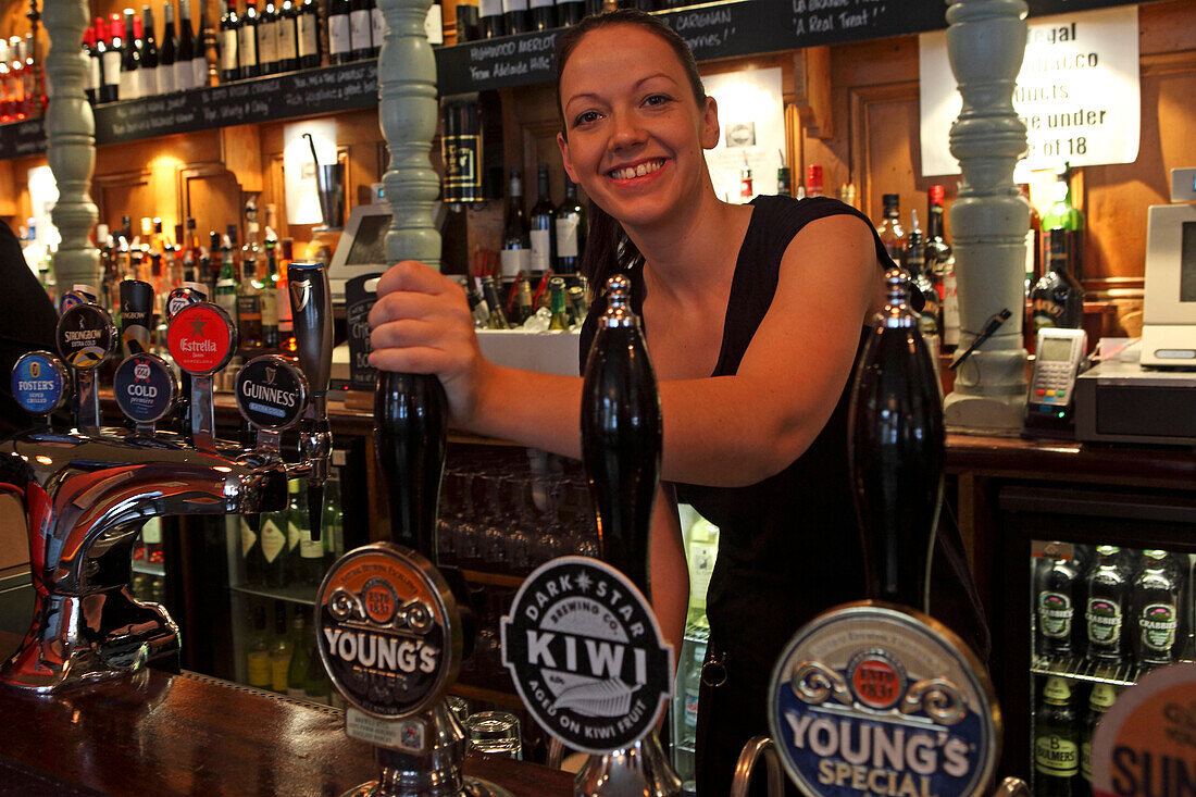 Barkeeper at beer pump, Covent Garden, London, Great Britain