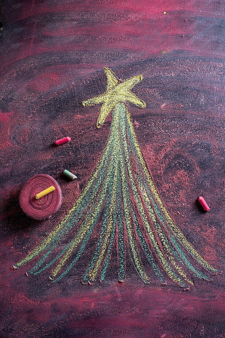 Small stylized christmas tree on blackboard with chalk.