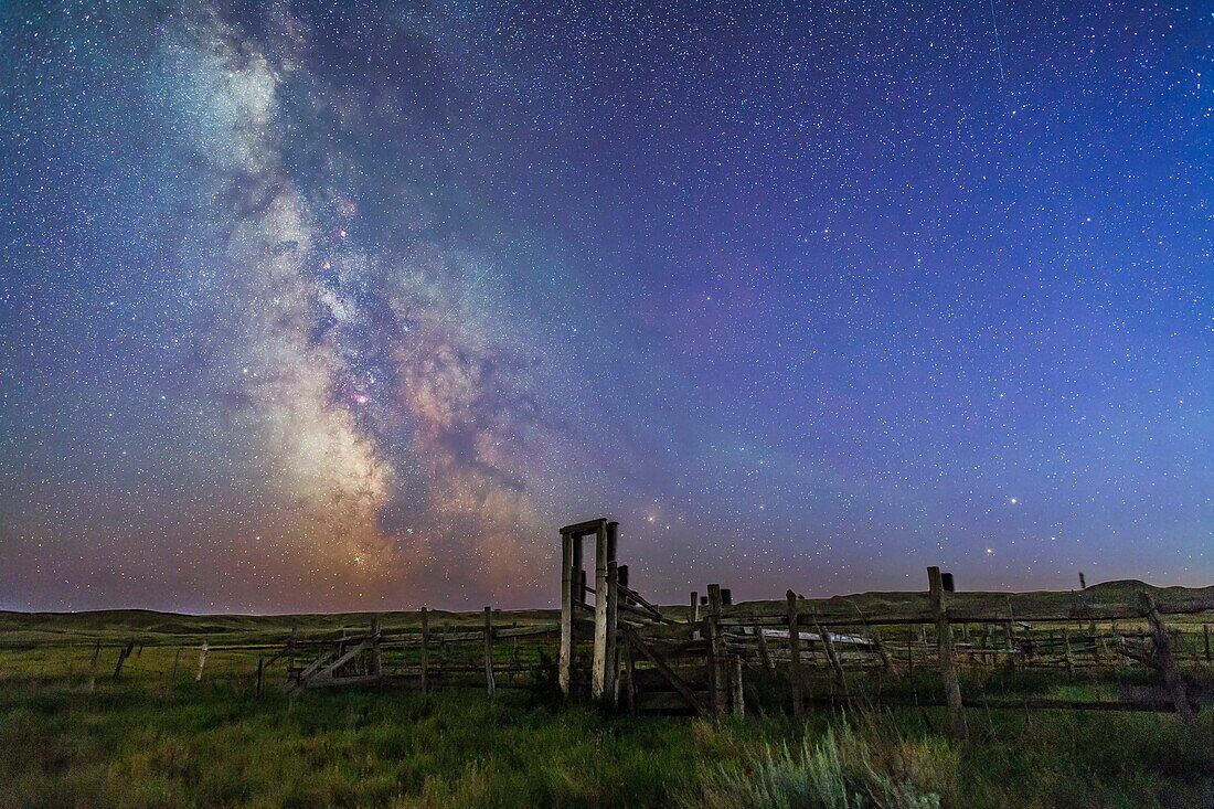 Mars (bottom) and Saturn in conjunction at right, and the Milky Way at left, in deep blue twilight before the sky got filly dark, over the old corral of the 76 Ranch, in Grasslands National Park, Saskatchewan, August 27/28, 2014. Antares and Scorpius are 