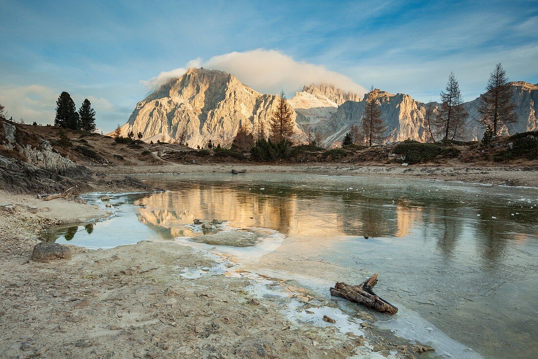 Autumn dawn at frozen lake Limides, Dolomites, Italy.