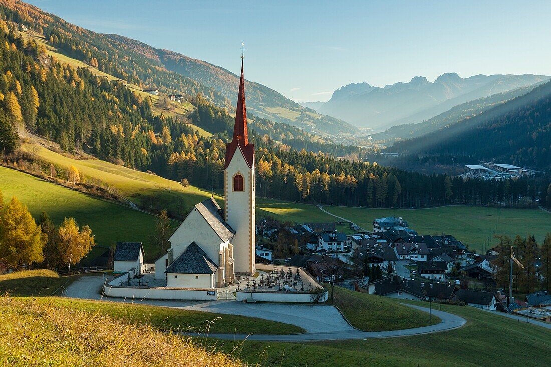 Autumn morning at iconic alpine church in Winnebach, South Tyrol, Italy.