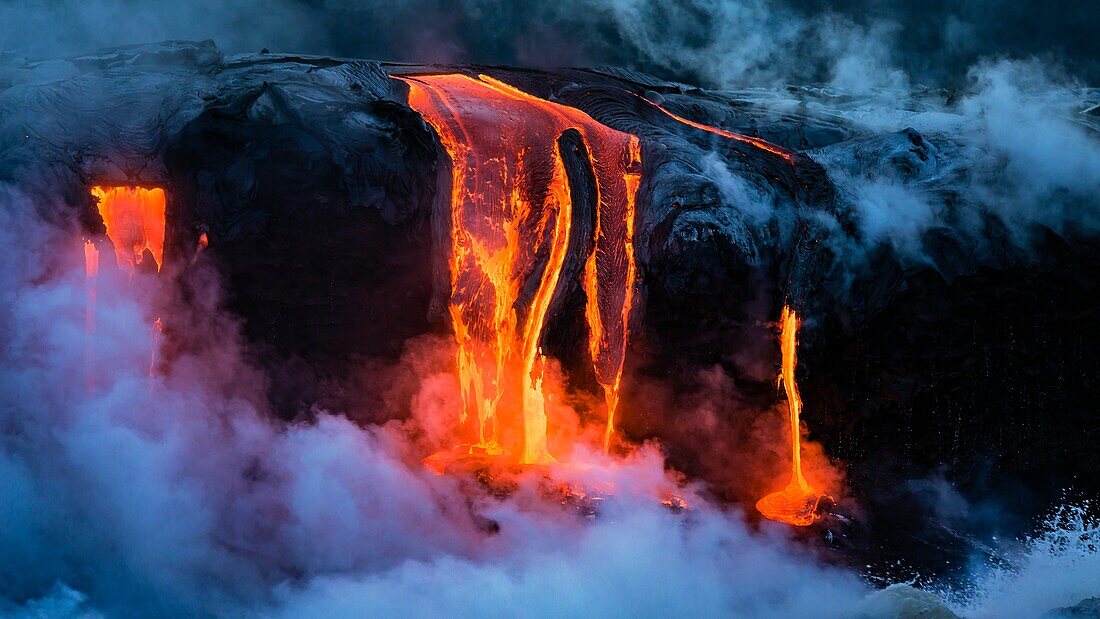 Lava flow entering the ocean at dawn, Hawaii Volcanoes National Park, The Big Island, Hawaii USA.