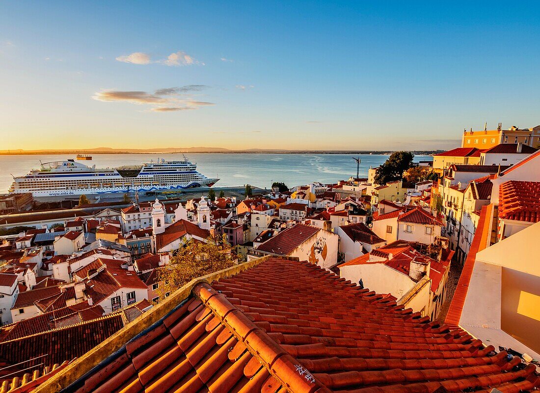 Portugal, Lisbon, Miradouro das Portas do Sol, View over Alfama Neighbourhood towards the Tagus River at sunrise.