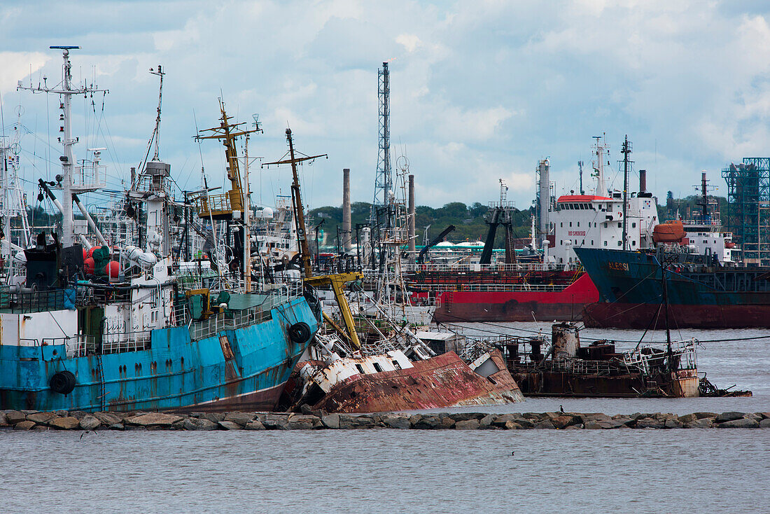 Rusty fishing boat shipwrecks in harbor