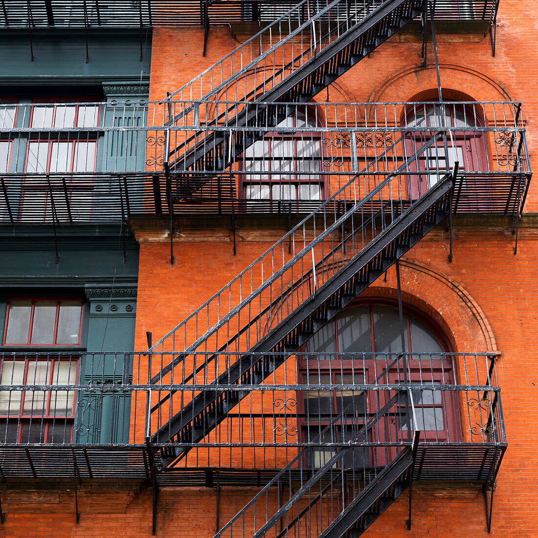 'Brick residential building with black metal fire escapes, Soho, Lower Manhattan; New York City, New York, United States of America'