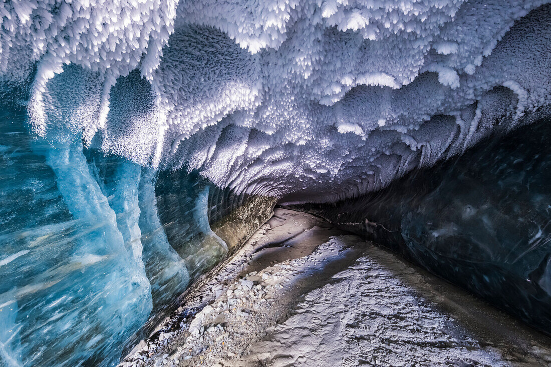 'Hoarfrost covers the ceiling of a tunnel stretching beneath the ice of Canwell Glacier; Alaska, United States of America'