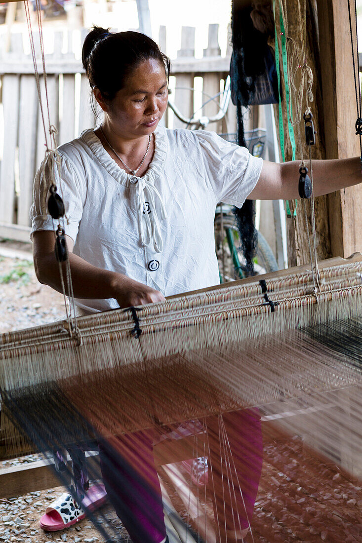 Tai Lue tribal woman using a traditional loom, Chiang Mai, Thailand, Southeast Asia, Asia