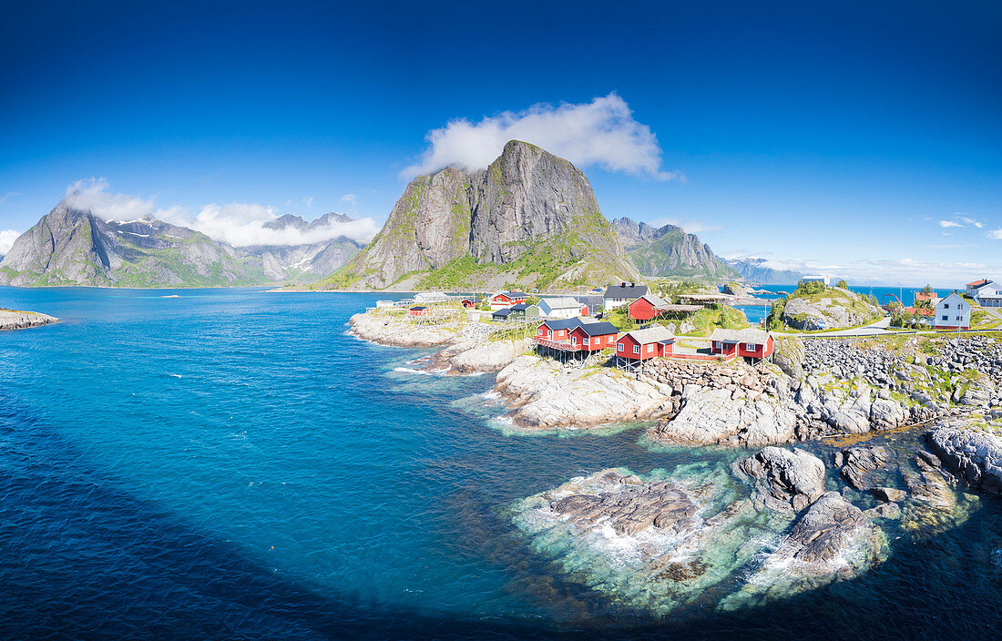 Panorama of the fishing village framed by blue sea and high peaks, Hamnoy, Moskenesoya, Nordland county, Lofoten Islands, Norway, Scandinavia, Europe