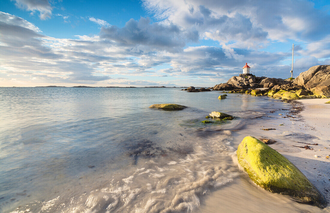 Midnight sun lights up cliffs and sandy beach surrounded by turquoise sea, Eggum, Unstad, Vestvagoy, Lofoten Islands, Norway, Scandinavia, Europe