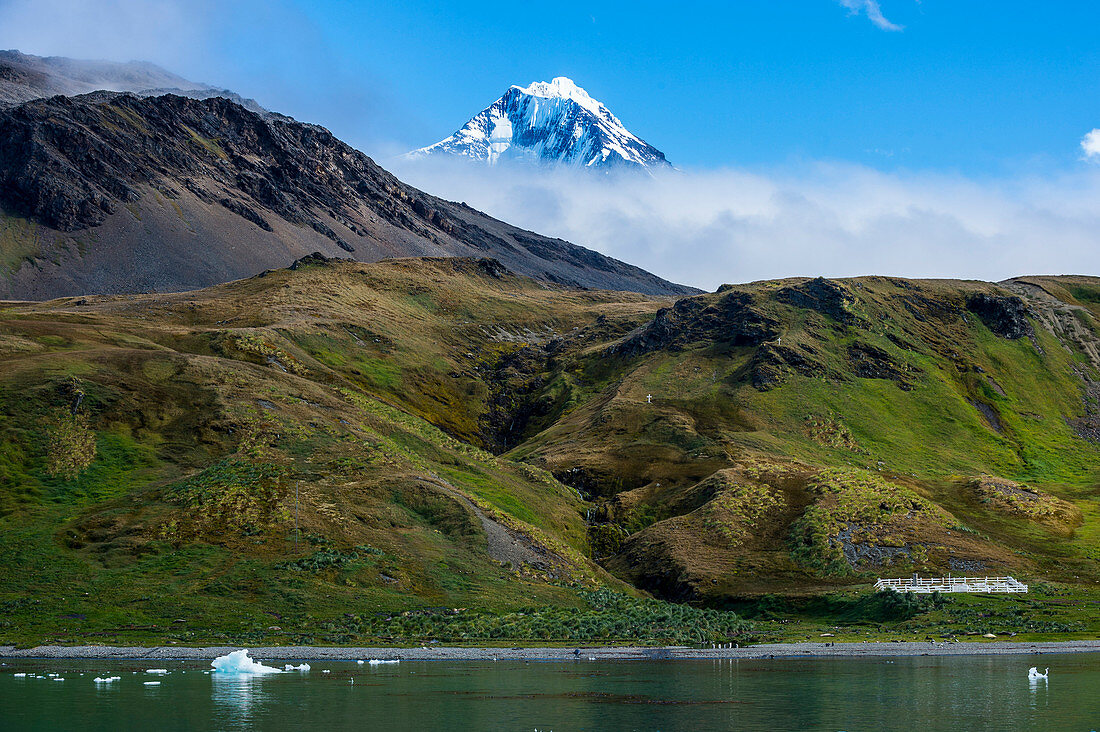 Snow capped mountain breaking through the cloud, Grytviken, South Georgia, Antarctica, Polar Regions