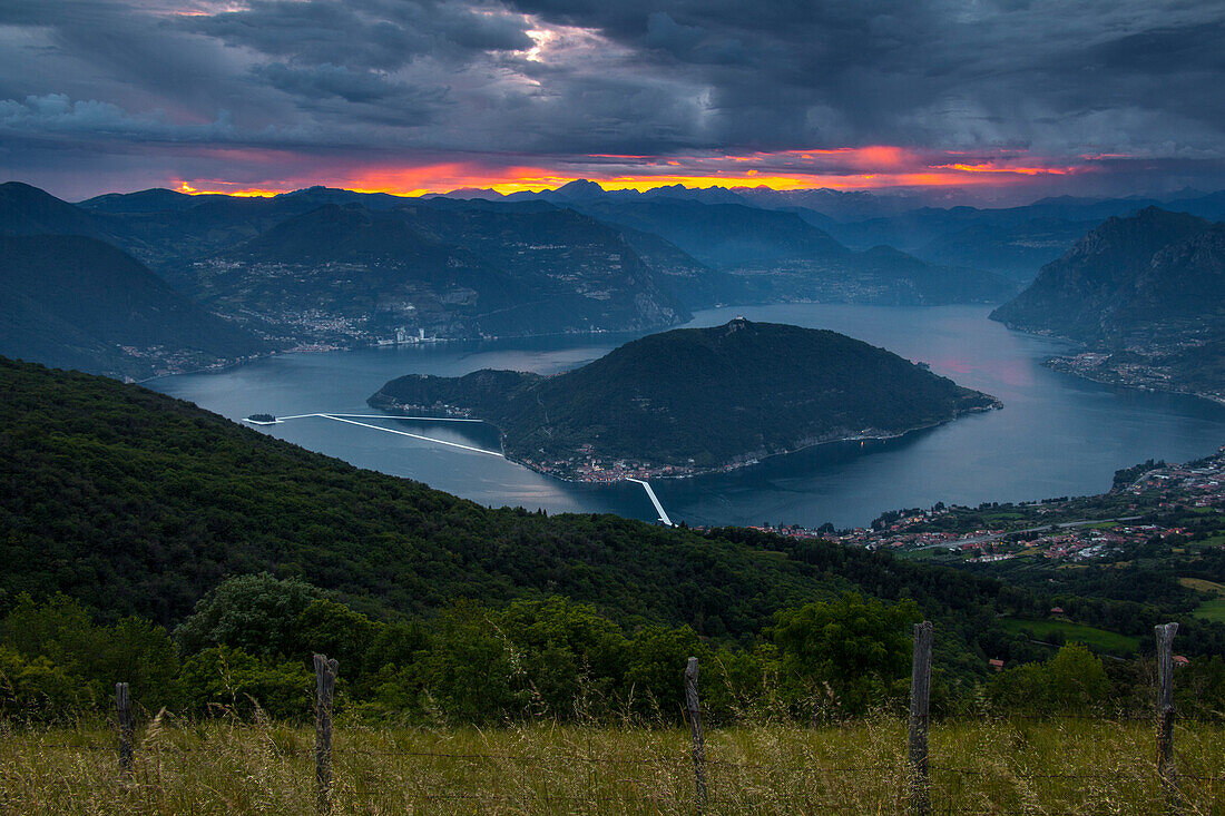 The Floating Piers in Iseo Lake at dusk , Italy, Europe