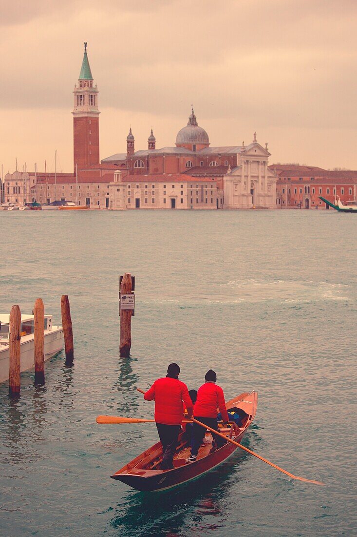 Europe, Italy, Veneto, Venice Gondoliers masked sailing towards the canal of Venice