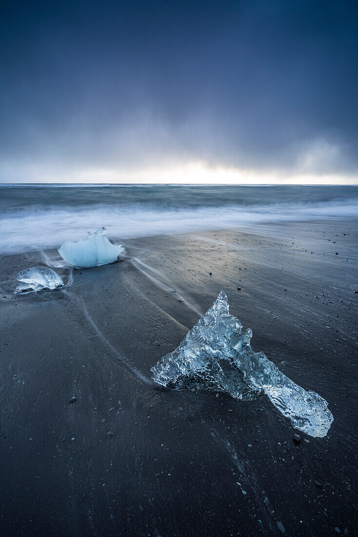 Ice blocks on the black sand beach in Jokulsarlon Glacier Lagoon, Eastern Iceland, Europe