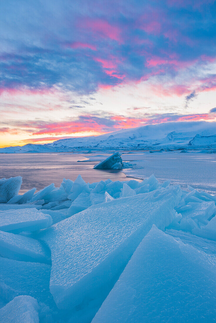 Jokulsarlon glacier lagoon, Iceland, Europe, Blocks of ice in the frozen lagoon on a winter sunset