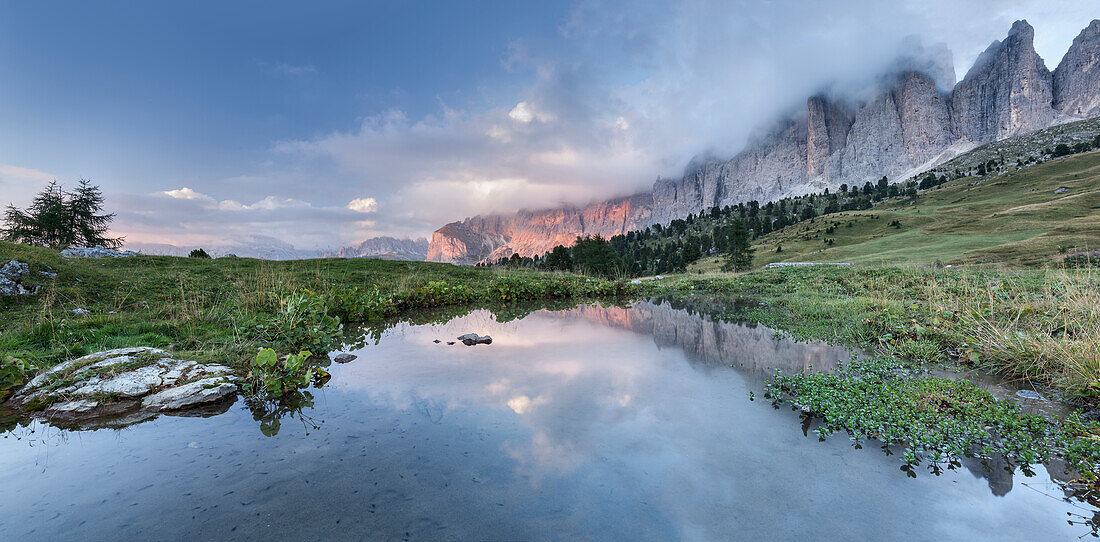 Europe, Italy, South Tyrol, Bolzano, Sella towers reflected on a little water pond near Sella pass