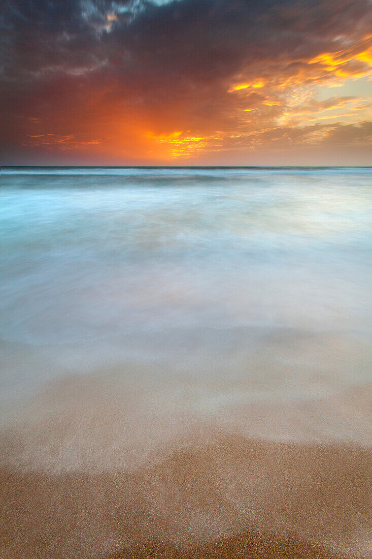 Catania, Sicily, Italy, Ethereal sea with clouds painted by the sunset's light