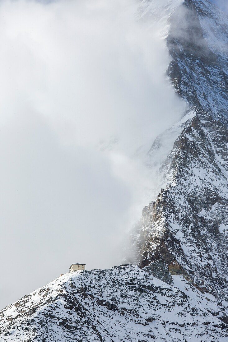 Hornli, hutte covered in the fog that hides the peak of the Matterhorn, Zermatt, Valais, Switzerland Europe