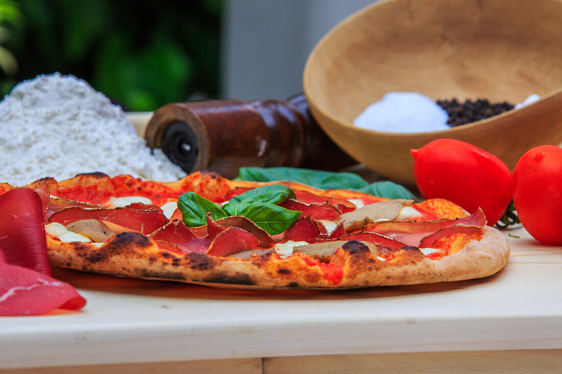 Pizza mushrooms and bresaola ready for consumption, Lombardy, Italy, Europe