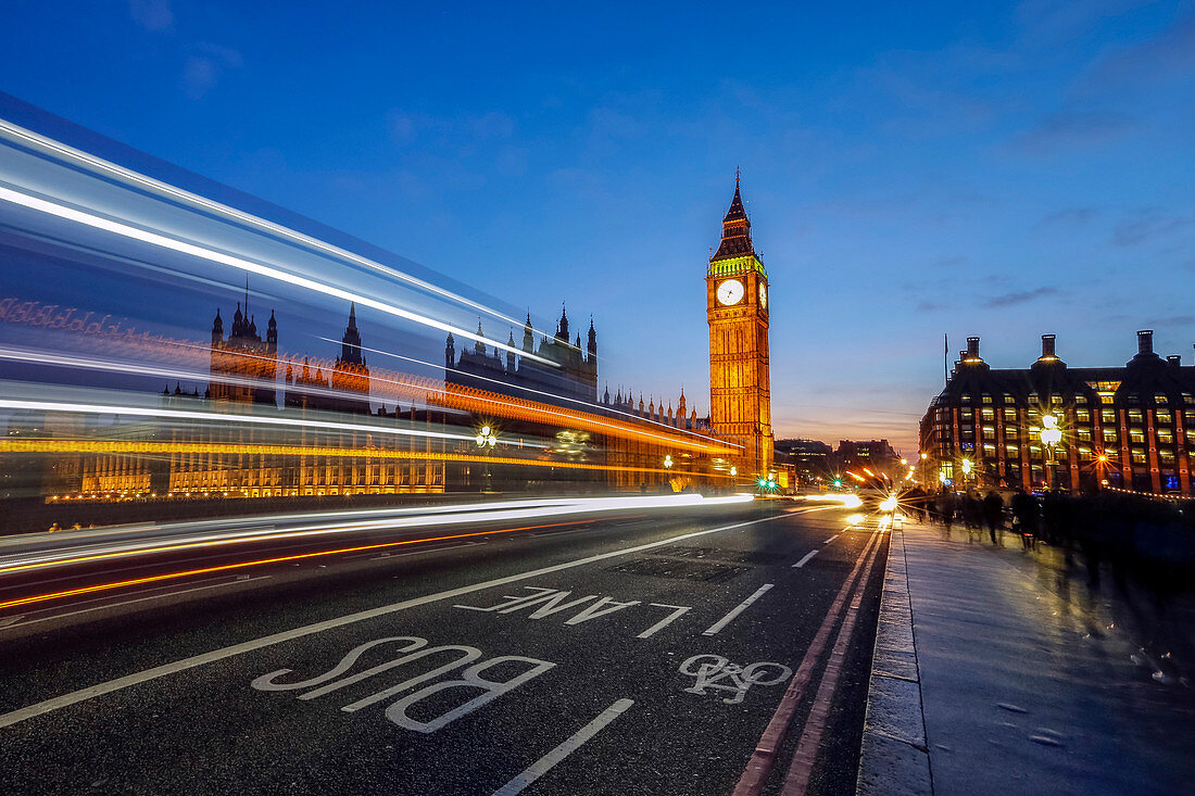 Doubledeckerbus runs towards Big Ben also called Elizabeth Tower, located north end of the Palace of Westminster in London United Kingdom Europe