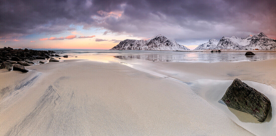 Panoramic view of the sandy beach of Skagsanden under a cloudy pink sky, Lofoten Islands, Northern Norway, Europe