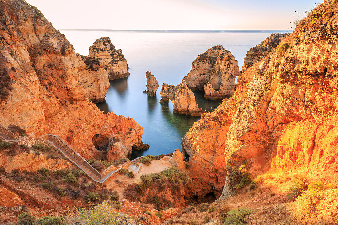 Golden sunrise on the red cliffs of Ponta da Piedade Lagos Algarve Portugal Europe