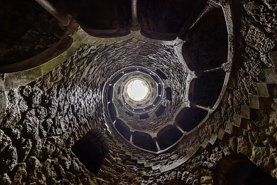 Spiral stairs and mystical atmosphere inside the towers of Initiation Well at Quinta da Regaleira Sintra Portugal Europe
