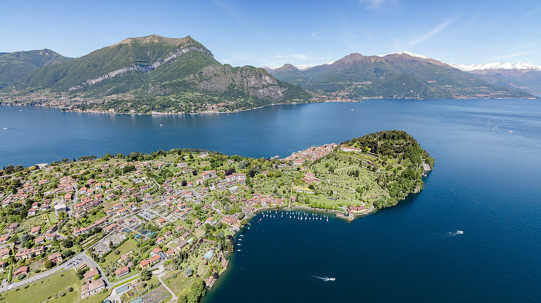 Aerial view of the village of Bellagio frames by the blue Lake Como and snowy peaks in background Lombardy Italy Europe