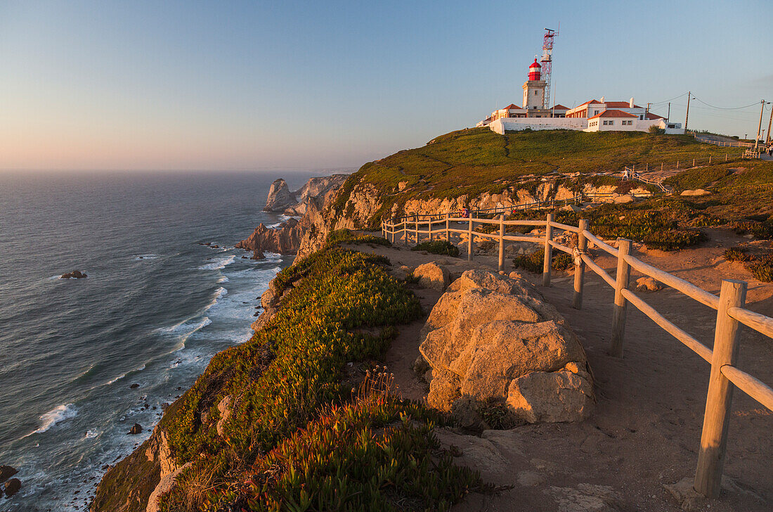 The colors of the sunset on the cape and lighthouse of Cabo da Roca overlooking the Atlantic Ocean Sintra Portugal Europe