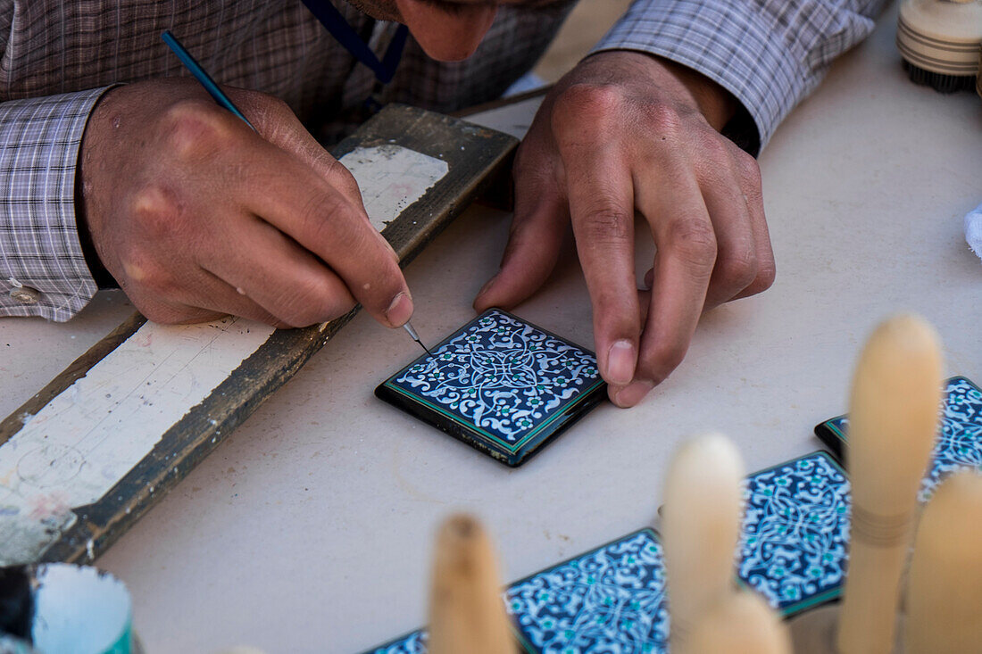 Khiva, Uzbekistan, Central Asia, An artist paints a majolica in Khiva