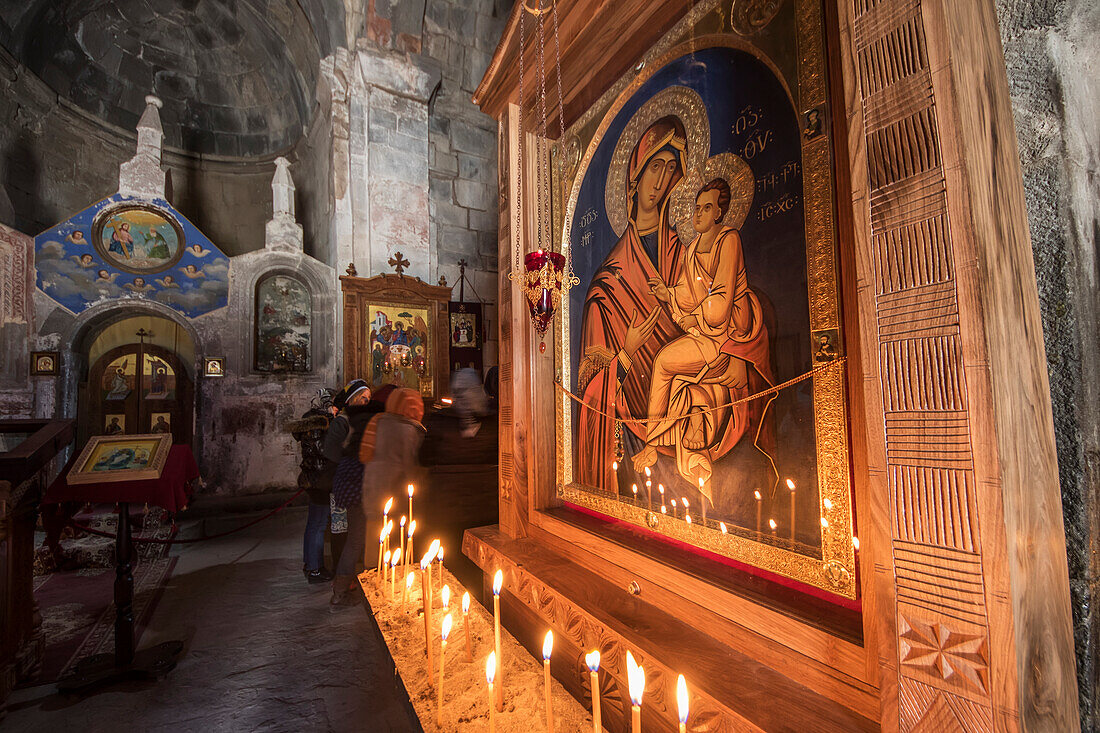 'Lit candles by a Virgin and Child icon in the interior of Gergeti Trinity Church; Kazbegi, Mtskheta-Mtianeti, Georgia'