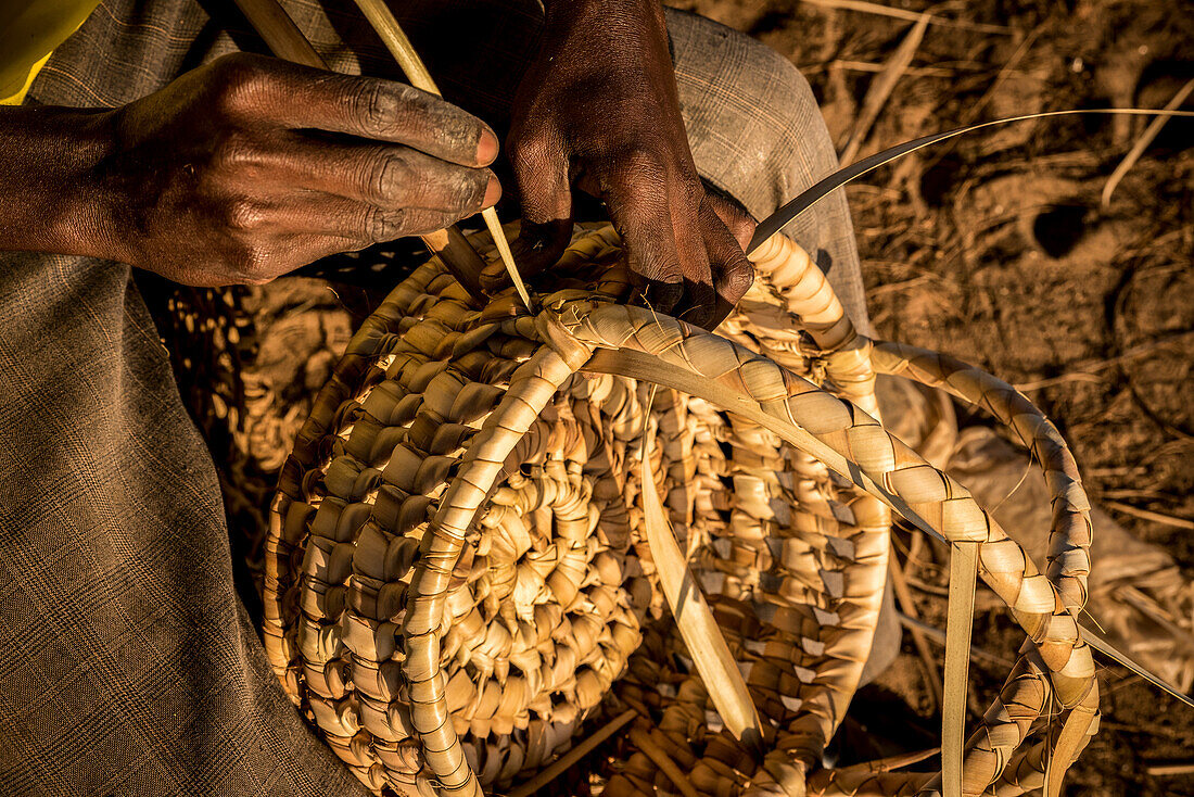 'Local craftsman weaving a basket; Maputo, Mozambique'
