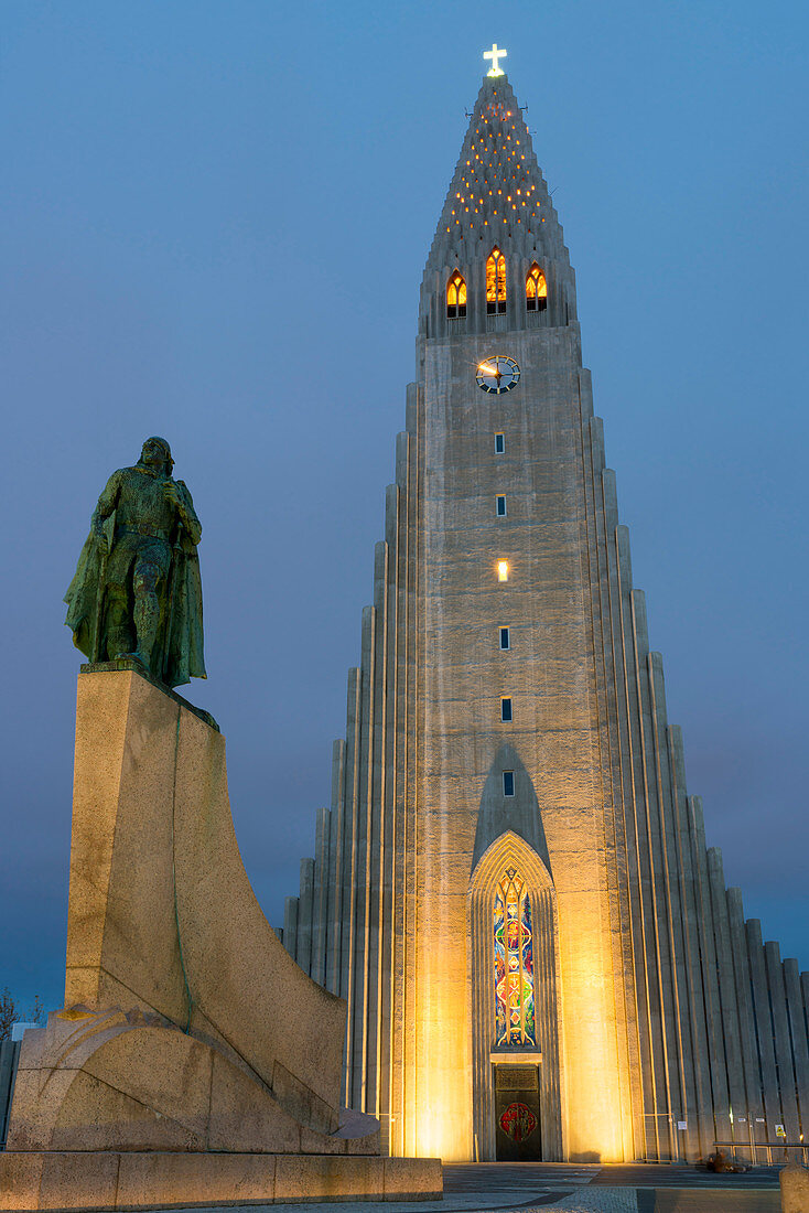 The Hallgrims Church with a statue of Leif Erikson in the foreground lit up at night, Reykjavik, Iceland, Polar Regions