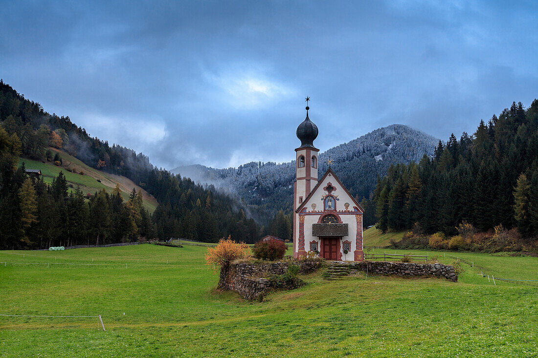 Clouds on Church of Ranui surrounded by meadows and woods in the fall, St. Magdalena, Funes Valley, South Tyrol, Dolomites, Italy, Europe