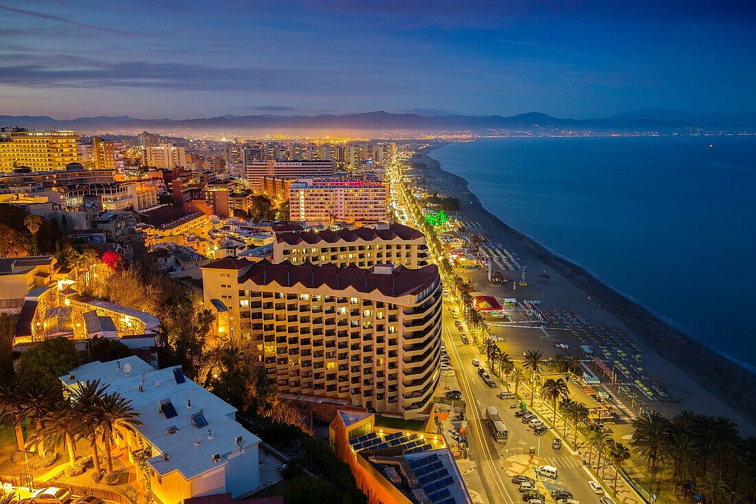 Panoramic landscape at dusk beaches, hotels and El Bajondillo, Torremolinos. Malaga province Costa del Sol. Andalusia Southern Spain, Europe.